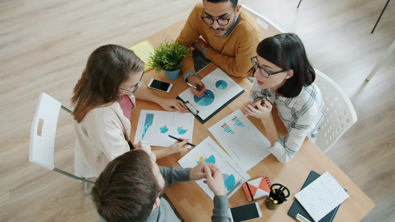 Junge Leute arbeiten in einem Workshop gemeinsam an Auswertungen am Tisch